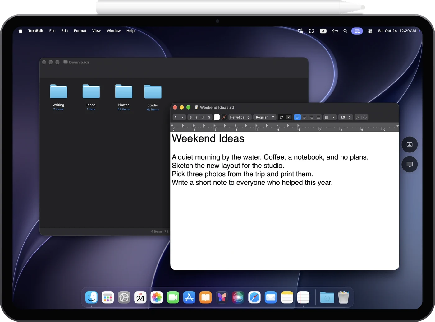 iPad Pro showing the Mac desktop, a Finder window and a document, with an Apple Pencil attached to its top edge
